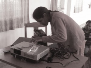 CC Nirmala Ekka learns how to use the interactive DVDs created by Gram Vaani